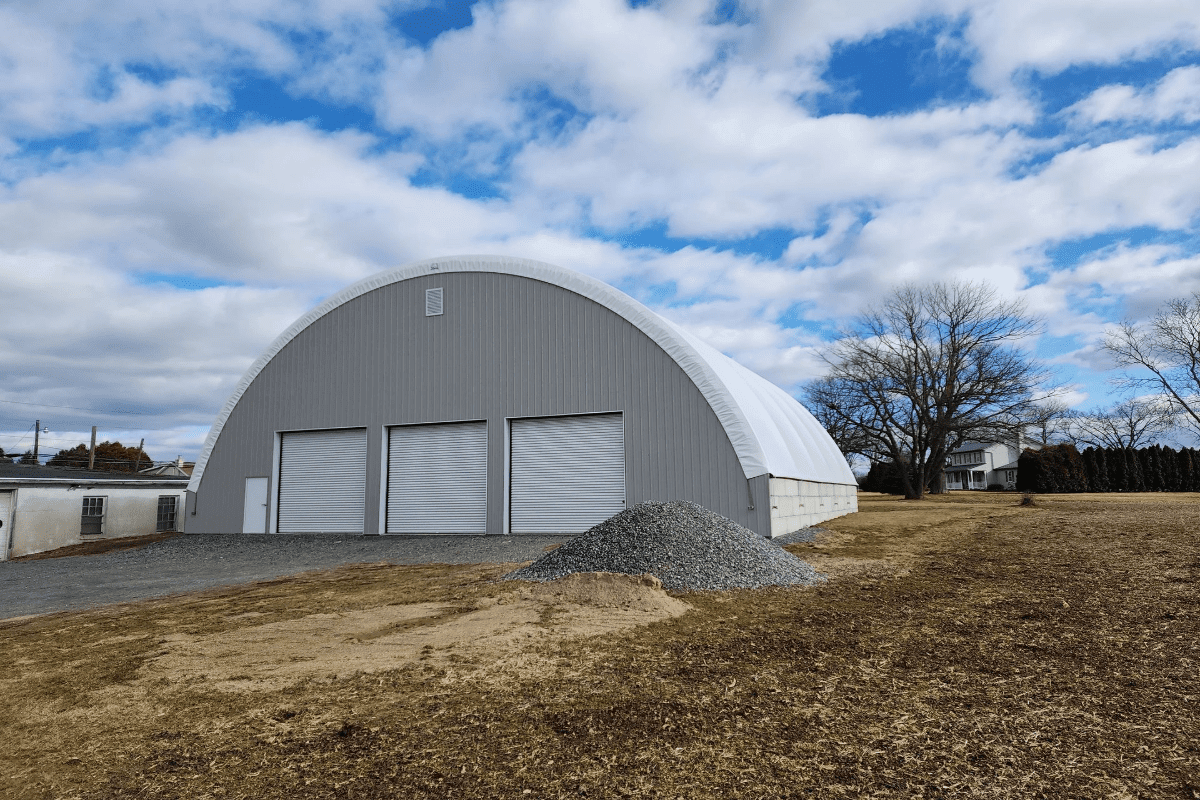 Gravel pile near large warehouse